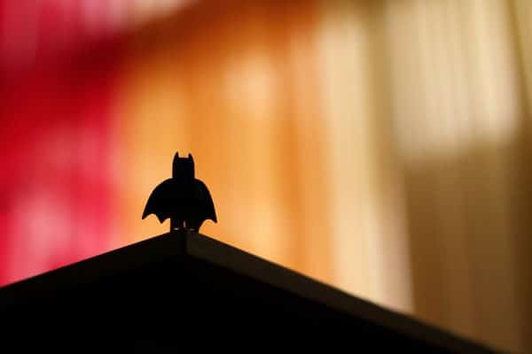 batman toy shasow with red and orange background
