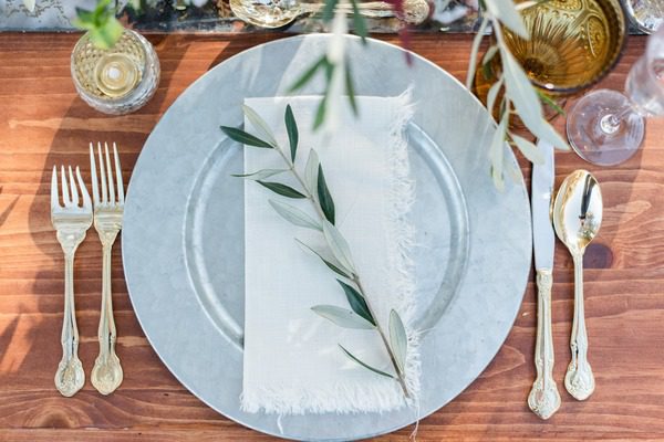 blue pace setting with gold cutlery